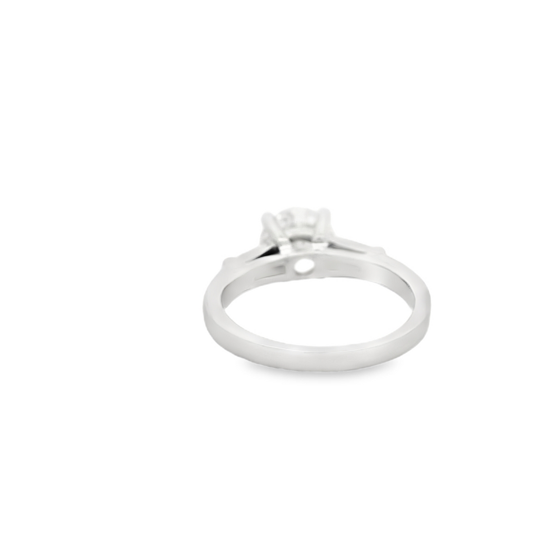 Estate Platinum Three Stone Engagement Ring set with 1 1.74 ct Round Diamond, F SI1, and 2 Baguette Diamonds, 0.46 ctw