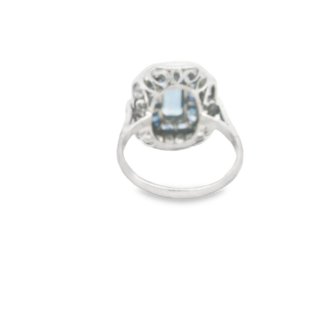 Platinum Estate Halo Gemstone Ring set with 1 Emerald Cut Aqua, 0.59 ctw, and 22 Round G/H, SI Diamonds, 0.70 ctw., and 28 French cut Sapphires, 0.84 ctw.,  total stone weight measures 2.13 ctw.
